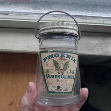 1920 PHOENIX QUEEN OLIVES SCHNULL & CO INDIANAPOLIS GLASS BUCKET JAR WITH HANDLE