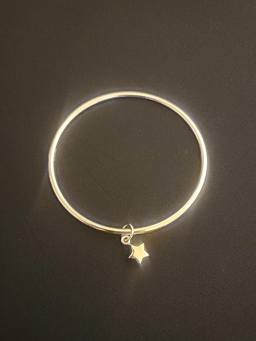 Bracciale Coach tono oro giallo con ciondolo stella