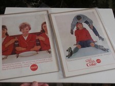 2 VINTAGE COCA COLA ADS ON CARDBOARD AND IN PLASTIC 1963 &1964 STEWARDESS