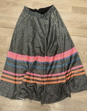 This grey sparkly character skirt features vibrant pink and blue ribbon trim