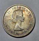 1964 Canadian 25-cent piece (commonly called a quarter).
