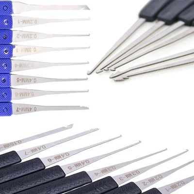 Assorted metal locksmith tools with black handles, including tension wrenches, wire cutters, and key removal tools.