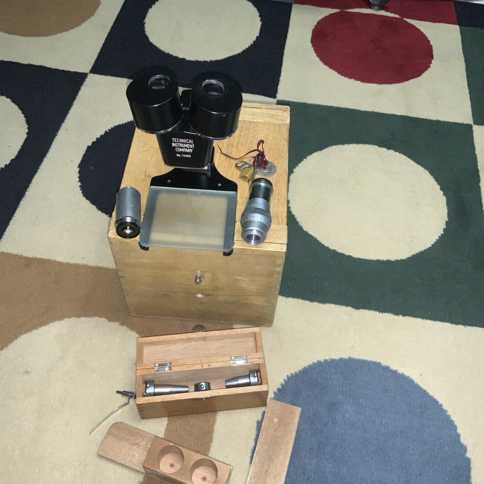A heavy-duty vintage scientific microscope arriving in its own dovetailed wood box — the kind of thing that looks incredible on a shelf AND still works.