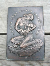 Old German Small Cast Wall Plaque: Mother feeding baby by Heinrich Moshage