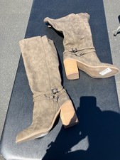 brown faux suede knee-high boots featuring a chunky block heel and a buckle stra