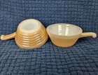 Two Vintage Fire King Peach Lustre Beehive Soup Bowls with a handle.