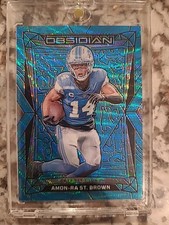 2024 PANINI OBSIDIAN 62 AMON-RA ST. BROWN INTERNATIONAL-BLUE WAVE
