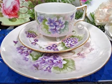 Germany tea cup and saucer trio purple violets artist signed footed teacup