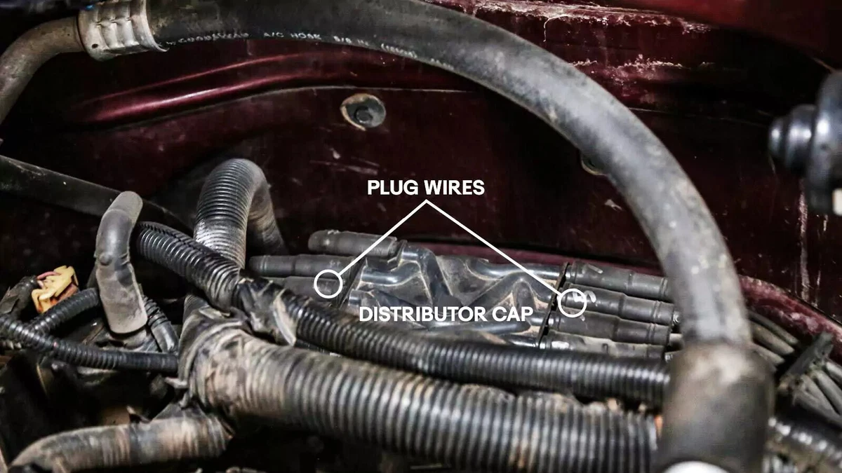 An annotated photograph shows the location of the distributor cap and spark plug wires.