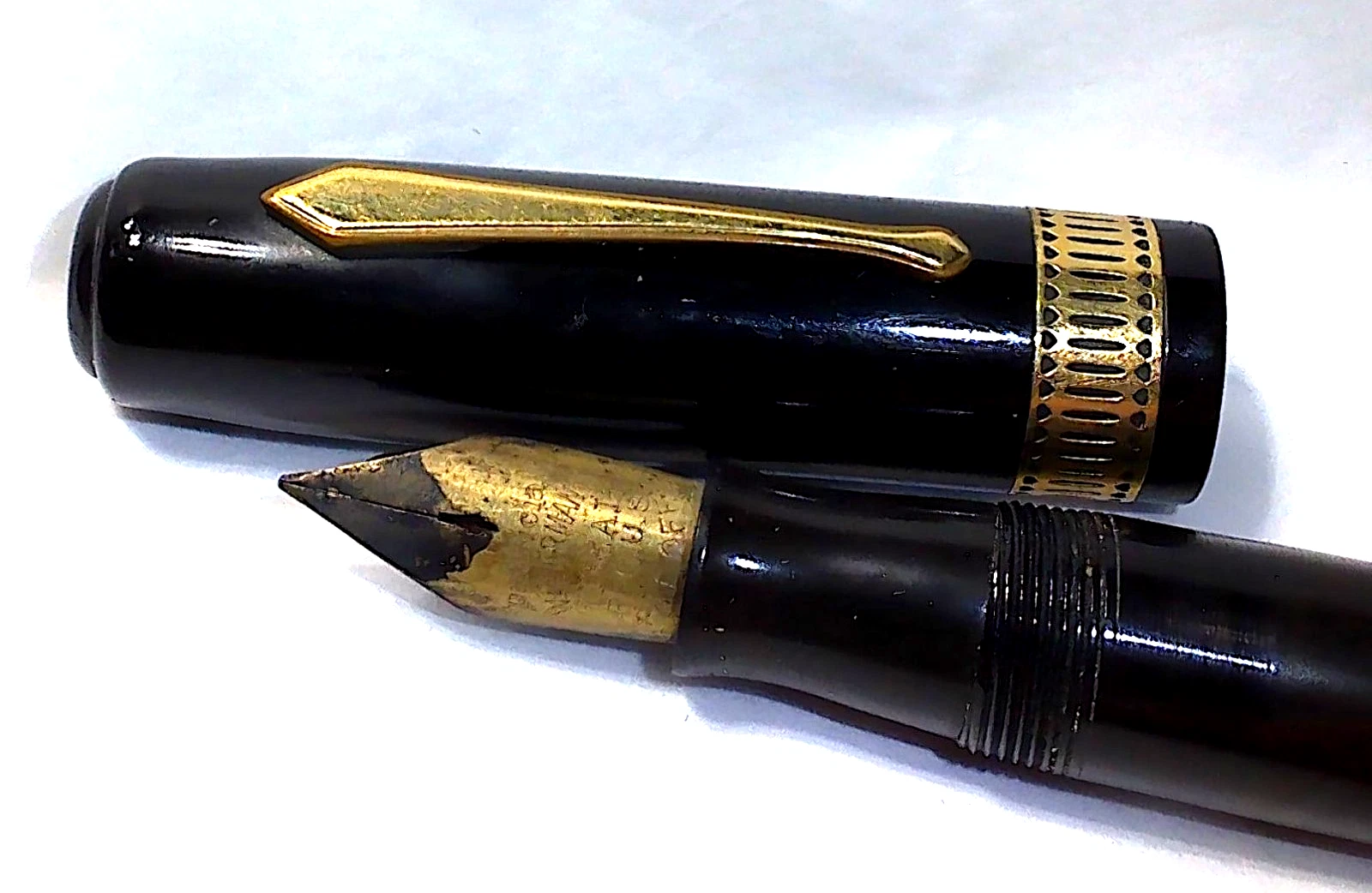 Black vintage Waterman Lady Patricia celluloid fountain pen with gold nib and silver-tone body detail on white background.