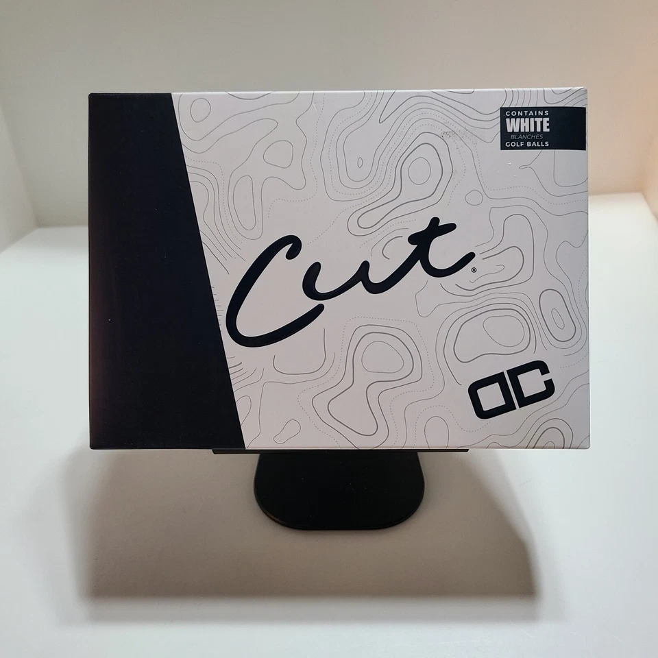 Caja de doce pelotas de golf Cut DC de alto rendimiento blancas con logotipo de DC de corte negro. Foto 2 de 4