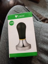 L-BEANS brand espresso coffee tamper with a black handle and stainless steel