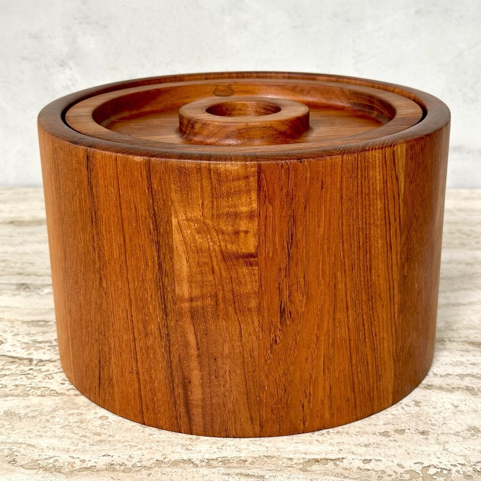 A staved teak Dansk ice bucket stamped with Jens Quistgaard's IHQ mark is authenticated MCM design royalty — a legitimate collectible.