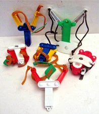 12 Old Mini Fold Up Sling Shots Vending Machine Toys