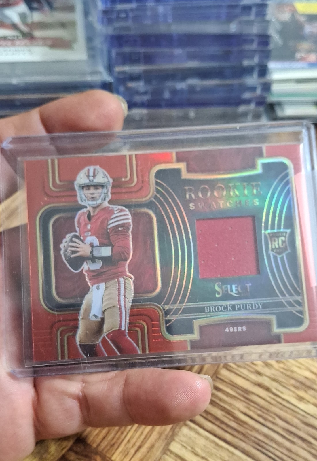 2022 Panini Select - Rookie Swatches Brock Purdy #RSW-17 Red Prizm (MEM, RC)