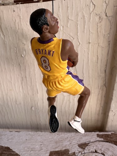 2003 Hallmark Hoop Stars ornament of Kobe Bryant in yellow Lakers jersey, purple side panels, holding basketball.