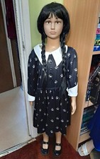 Full child plastic mannequin, with Wednesday Addams inspired outfit.