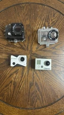 Lot of 2 Action Cameras – GoPro Hero + Head 1080P with Cases