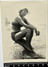 Pretty young woman in swimsuit and panama on the beach, women's bikini Old photo