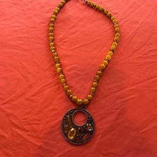 Vintage Yellow beaded necklace w/ a large circular pendant feat geometric shapes