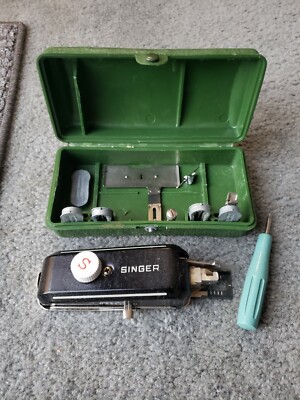 singer held hand sewing machine