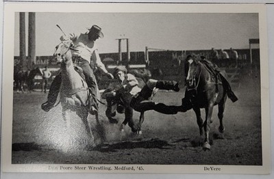 1945 Medford, OR RODEO RPPC Postcard ''Dan Poore Steer Wrestling'' DeVere