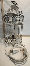 Ornate metal framed bird cage lamp with distr...