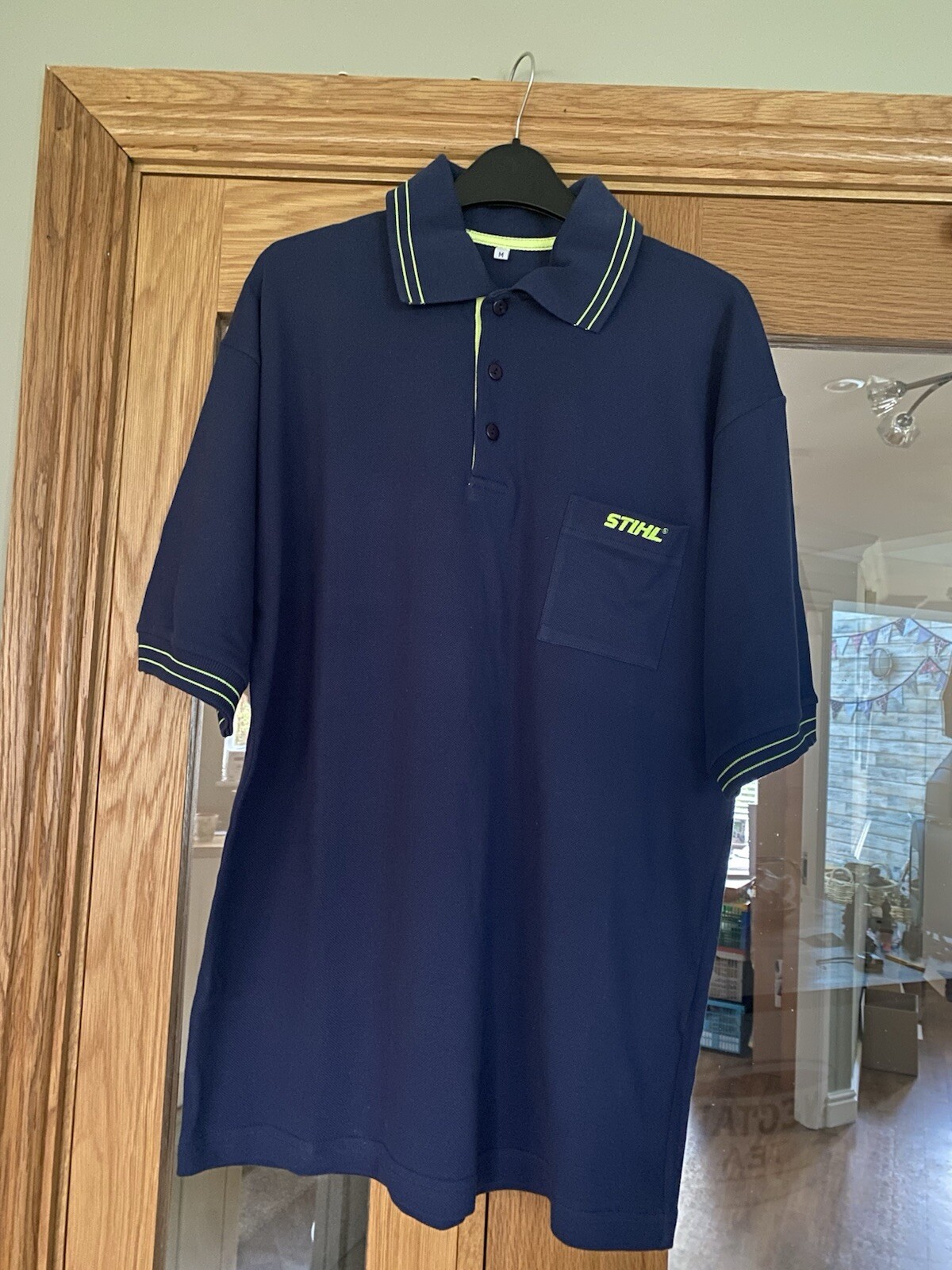 Polo Stihl blu con righe doppia fila verde lime e logo Stihl taglia M