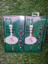 2 Boxed sets of 6 Christmas House wine & beverage charms each box different