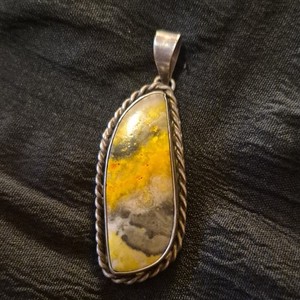 Navajo-style sterling silver pendant features a striking Bumblebee Jasper stone