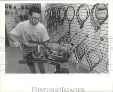 1990 Press Photo Racquet stringer Trevor Abernathy re strings a racquet.