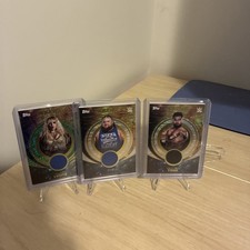 Lot Of 3 Numbered Relics From Universe WWE. Otis, Nikkita Lions, Cruz Del Toro