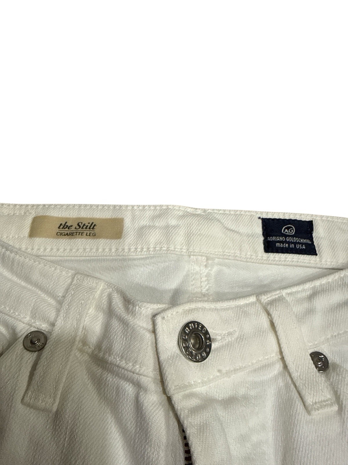 White AG Adriano Goldschmied jeans 25R with button closure, belt loops, and branded leather patch on waistband.