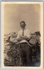 Vtg B&W Snapshot Smiling Man Arms Crossed Straw Hat Tie Tree Trunk 1920s