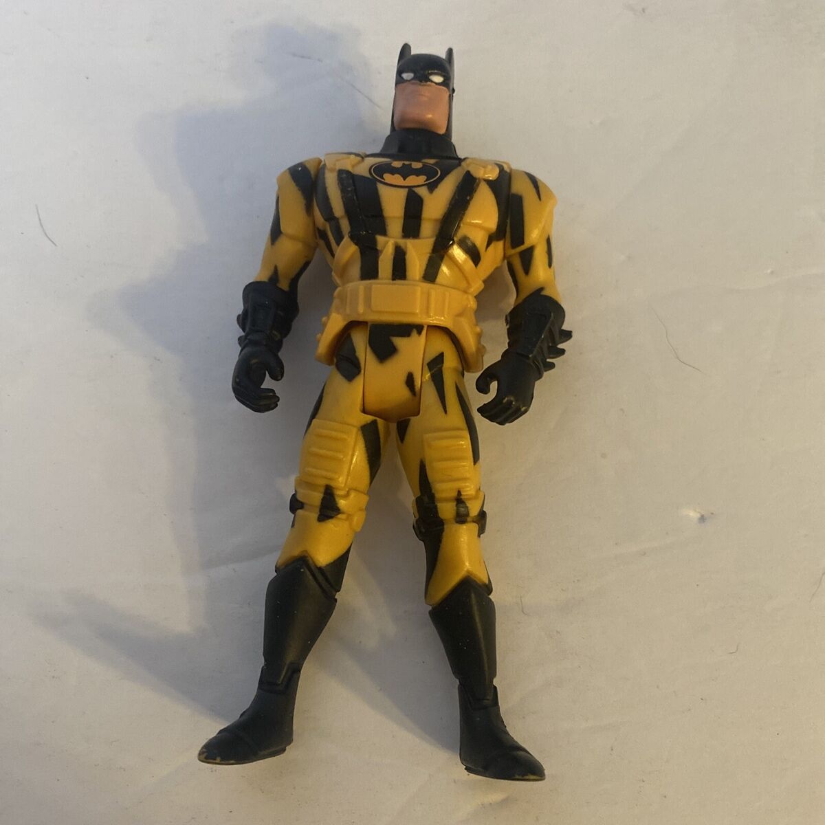 Black and yellow Batman action figure near MacBook Pro photo