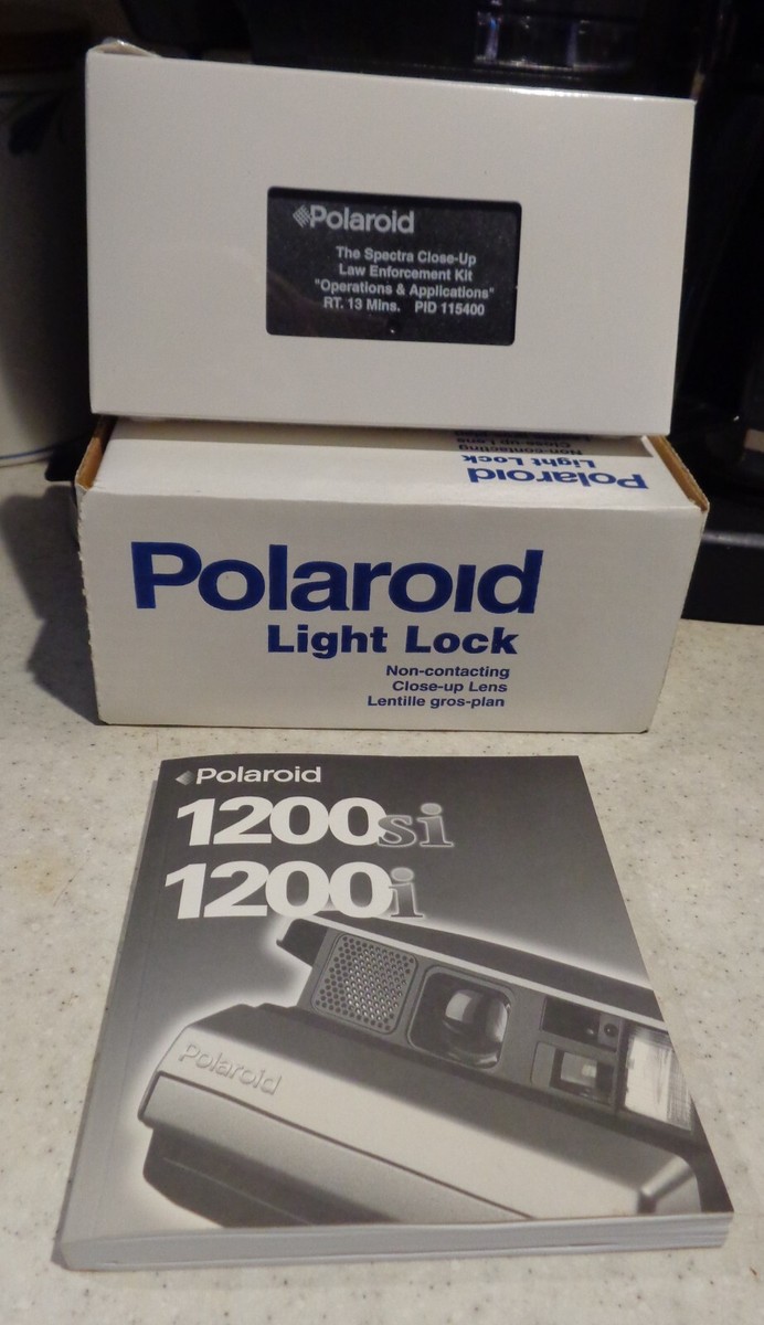 Polaroid 1200si Camera, Polaroid Bag, VHS tape, Owner's Manual, and Light Lock Polaroid 1200si Camera, Polaroid Bag, VHS tape, Owner's Manual, and Light Lock
