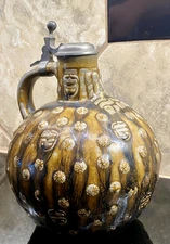 Western Germany Bartmann pottery jug with bearded man, pewter lid 