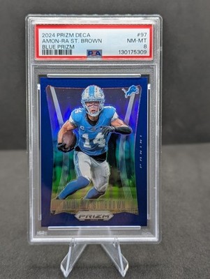 2024 Panini Prizm Deca - Amon-Ra St. Brown #97 Blue Prizm /149 PSA 8