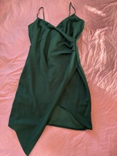 Emerald green cocktail dress with wrap-style front and side ruching.