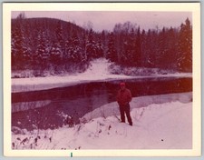 Vtg B&W Snapshot Man in Red Jacket Hat By Snowy Riverbank Winter Forest 1970s