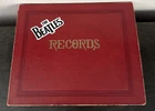 LOT OF 12 BEATLES VINTAGE 45’s FROM VARIOUS RECORD LABELS INCLUDING STORAGE BOOK