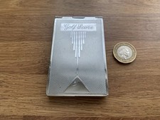 Biały metalowy uchwyt na kartę wyników do golfa z kartami wyników.