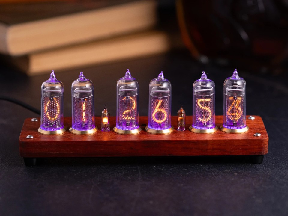 Handcrafted complete Nixie clock with authentic Soviet IN-14 tubes housed in a warm wood case with brass ring accents — desk art meets timekeeping.