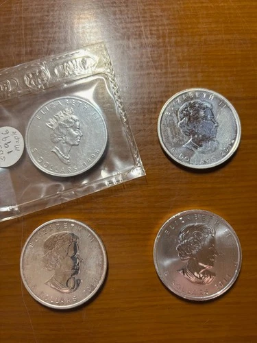 Four Maple Leafs: 1–1996 Mint Sealed, 2–2011 & 1–2012 Maple Leafs