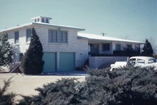 1960 Slide Daytime View Two Level Home with Classic Four Door Car on Driveway