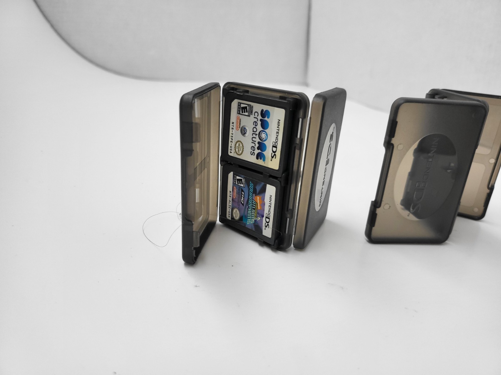 3 NEW OFFICIAL NINTENDO DS CLEAR BLACK 4 GAME CARTRIDGE CASE HOLDER 12 TOTAL 18N