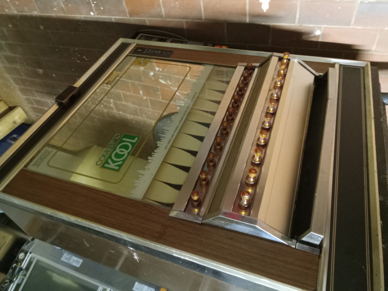 Brand not known. But old cigarette dispenser/pull vending machine
