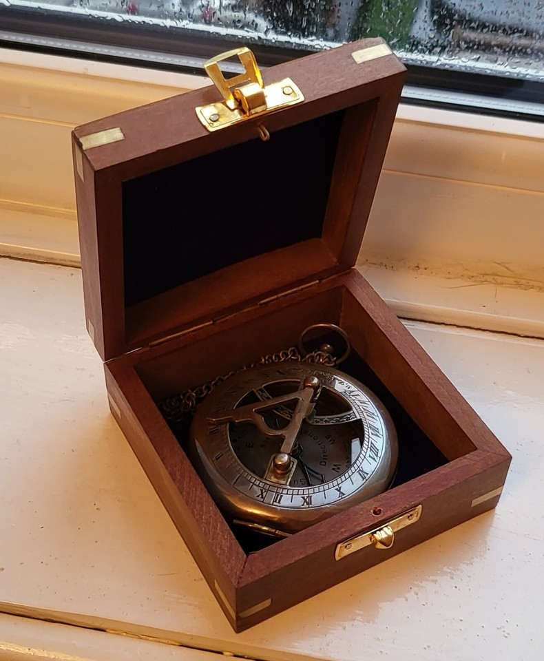 A pocket-sized antique sundial watch with compass — a functional Victorian curiosity that doubles as a wearable conversation piece.
