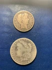 ( 1 ) VF 1899-O Barber Half Dollar, ( 1 ) Fine 1899-O Morgan Silver Dollar