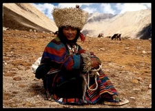 Postcard Khampa Shepherd Girl in Traditional Dress, Mountains in Background